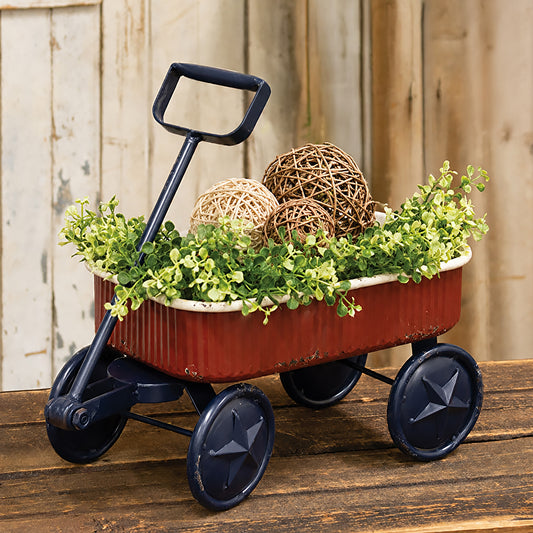 Rustic Americana metal wagon with distressed red finish navy star wheels and vintage patriotic farmhouse decor styling