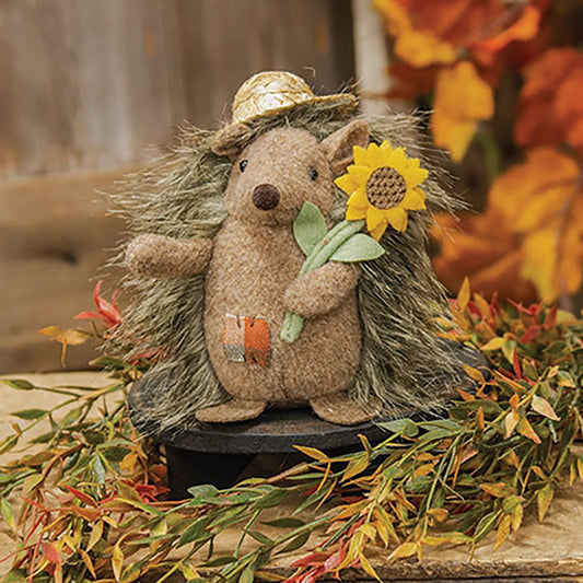Stuffed hedgehog plush with straw hat and felt sunflower, freestanding autumn decor with brown fuzzy fabric and orange patch