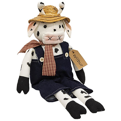 Weighted fabric cow doll with straw hat and “Wilbur” name tag, country decor accent for shelf or tabletop