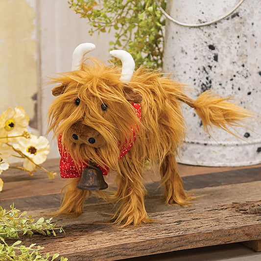 Fluffy Highland cow plush with shaggy brown fur, red bandana, and rustic bell for farmhouse décor.