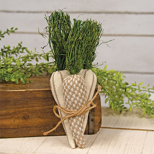 Set of three neutral-toned fabric carrots with raffia tops and jute bow