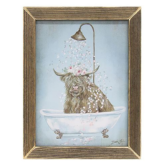 Rustic framed print featuring a highland cow in a bathtub with flower crown and falling petals on blue background