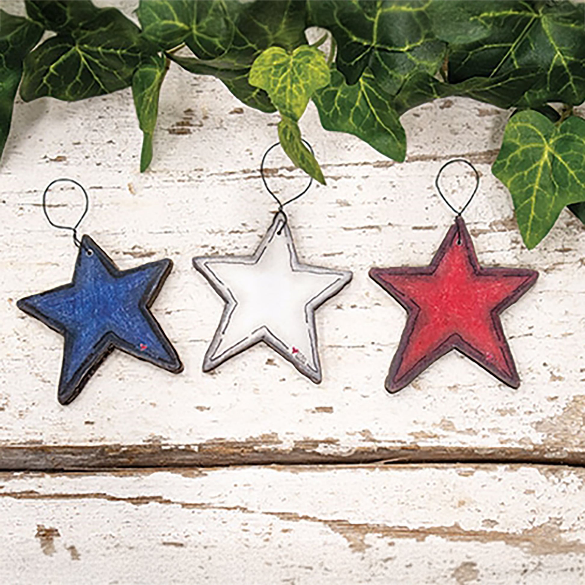 Set of three patriotic wooden star ornaments with rustic red white and blue farmhouse Americana styling