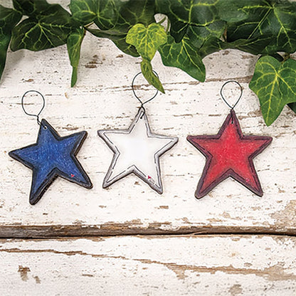 Set of three patriotic wooden star ornaments with rustic red white and blue farmhouse Americana styling