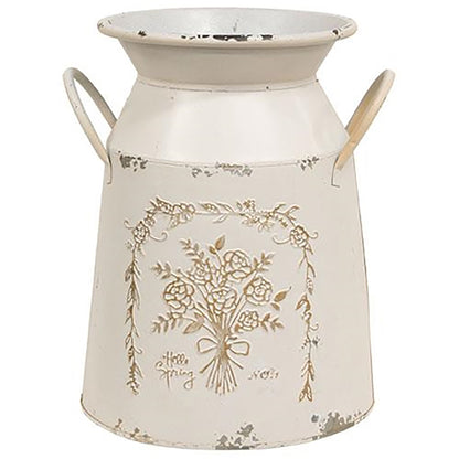 Cream-colored metal milk can with distressed finish and “hello spring” embossed on the front