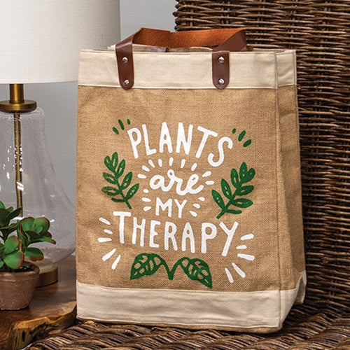 Jute tote bag with “plants are my therapy” text and green leaf doodles