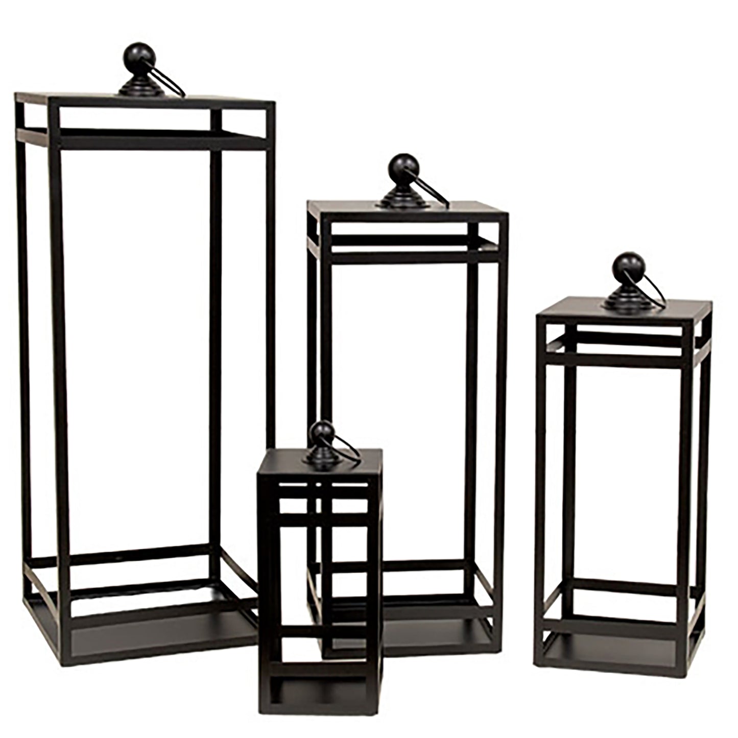 Black geometric metal lantern set with open frame design and swing handles styled for rustic home decorating