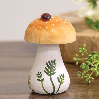 Handpainted wooden mushroom with ladybug sitting on brown cap, white spots, and green leaf details