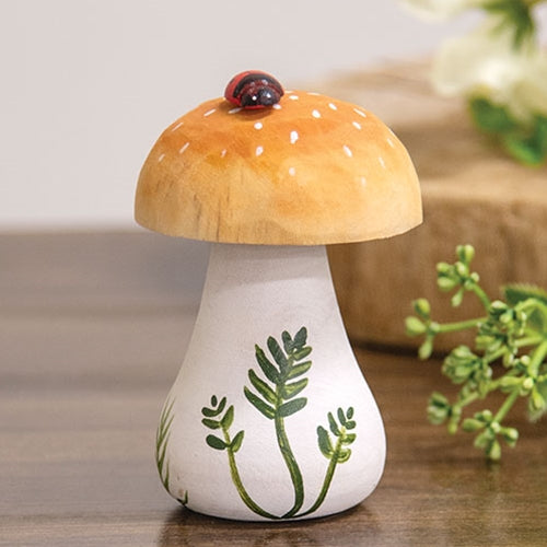 Handpainted wooden mushroom with ladybug sitting on brown cap, white spots, and green leaf details