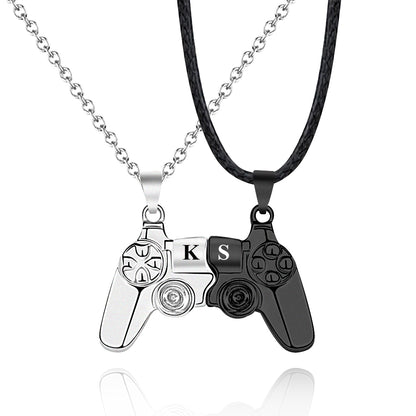 Matching gaming necklaces for couples, showing black alloy controller charms with initials and a magnetic attraction when placed together.