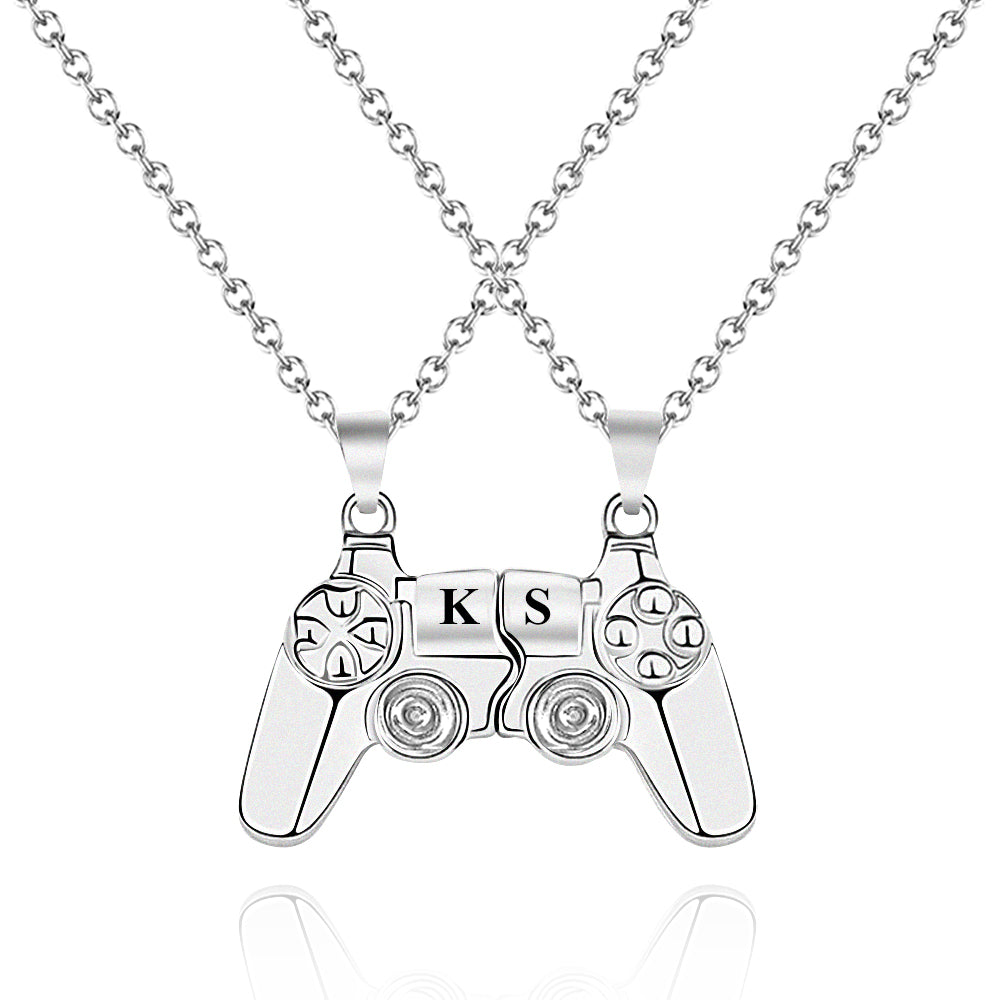 Magnetic video game controller pendant set for gamers, displayed on a sleek black background, highlighting its unique split design.