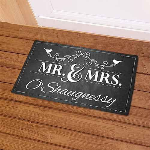 Personalized Mr. and Mrs. welcome doormat with last name in modern script, shown on front porch