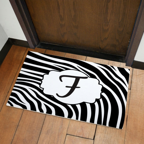 Zebra print welcome doormat with bold black and white pattern, soft fleece surface, and non-slip latex backing. Perfect for indoor and outdoor use.