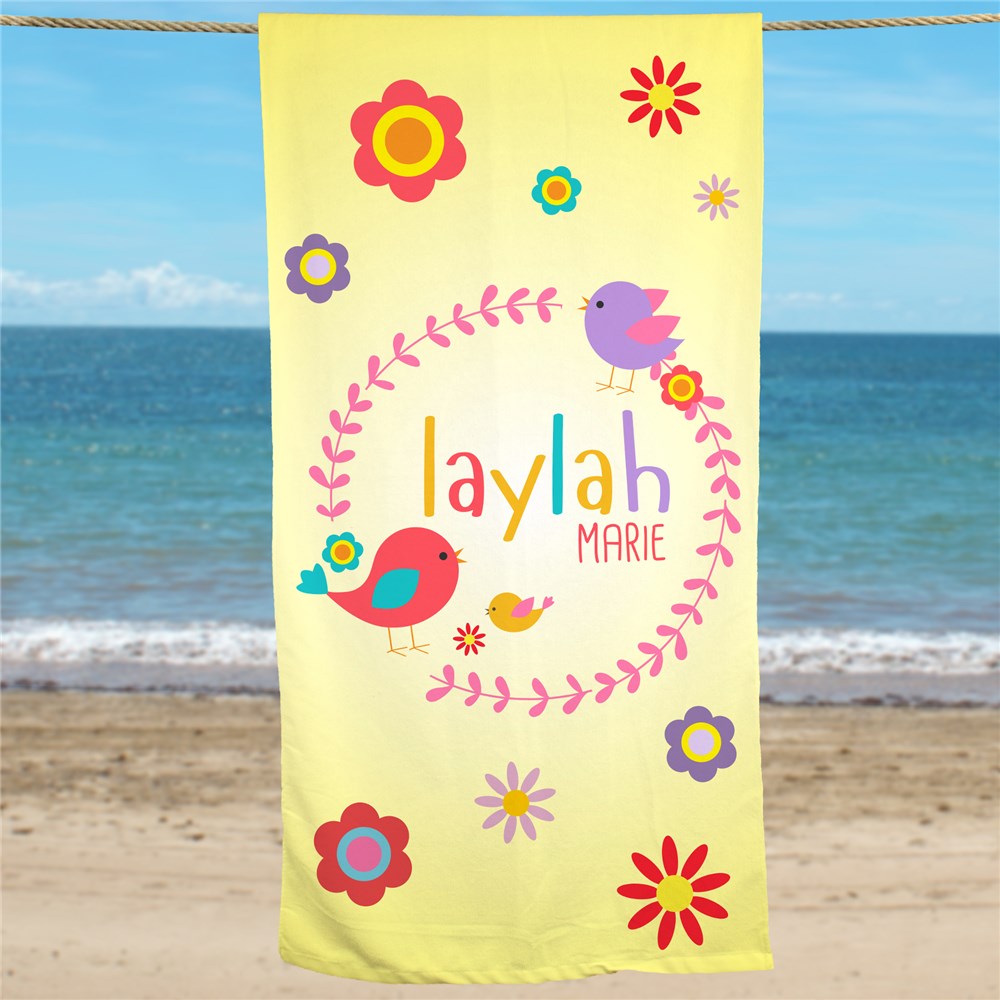 Personalized yellow beach towel with bird and flower design, printed with child's first and middle name