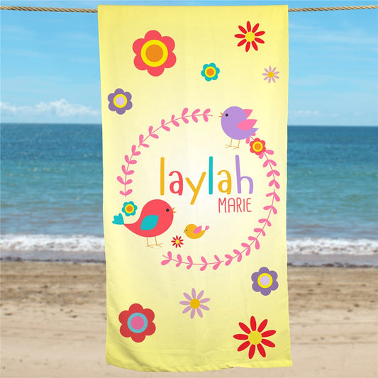 Personalized yellow beach towel with bird and flower design, printed with child's first and middle name