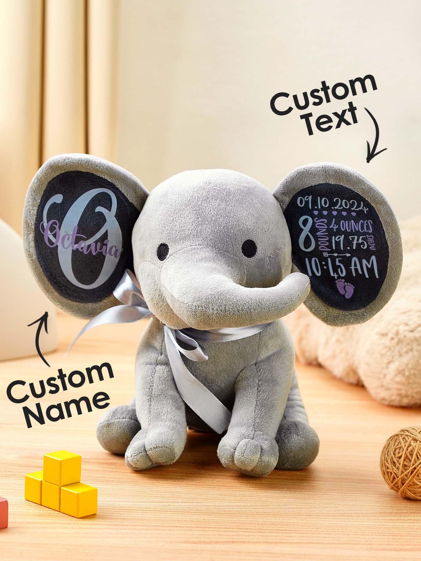 Stuffed elephant toy with a personalized name embroidered on its body, with an overlay indicating the custom name option.