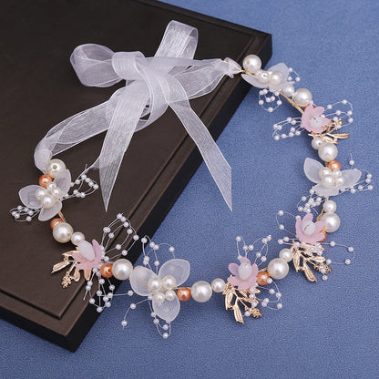 A floral crown featuring a mix of white, pink, gold, and copper (rose gold) accents, with delicate polyester blooms and pearl details, perfect for baptisms, first communions, and special occasions.