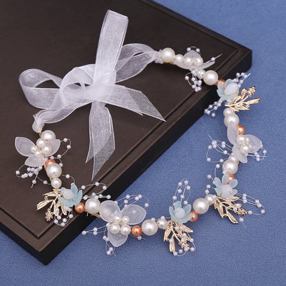 A floral crown featuring a mix of white, pale aqua, gold, and copper (rose gold) accents, with delicate polyester blooms and pearl details, perfect for baptisms, first communions, and special occasions.