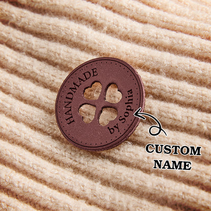 Handmade garment labels for crafters, knitters, and sewing artists. Custom synthetic leather tags for small business branding.