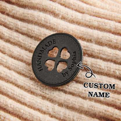 Personalized fiber art labels made from vegan leather. Custom engraved tags for handmade garments, knitting, and crochet.