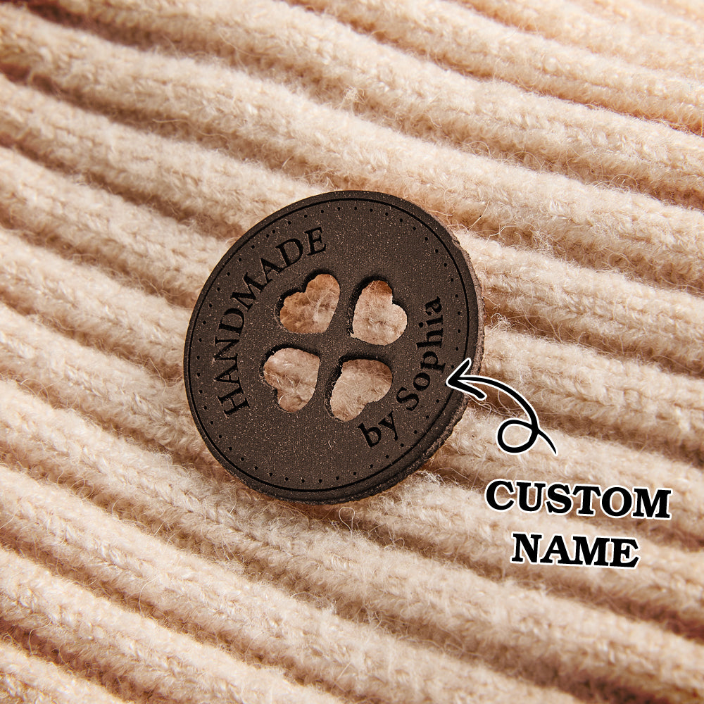 Custom engraved vegan leather tags for handmade crafts, ideal for knitting, crochet, and sewing businesses looking for personalized branding.