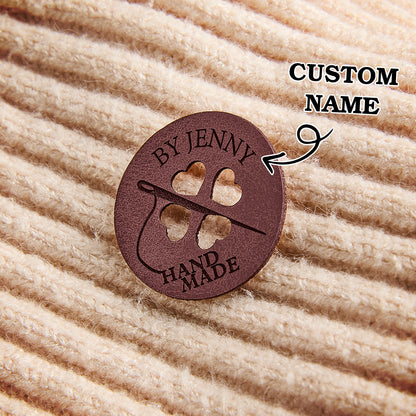 Custom engraved faux leather tags for knitting, crochet, and sewing projects. Ideal for small business branding and handmade craft labels.