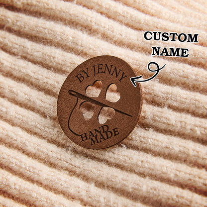 Handmade leatherette product tags with custom name engraving for personalized knitting, crochet, and sewing accessories.