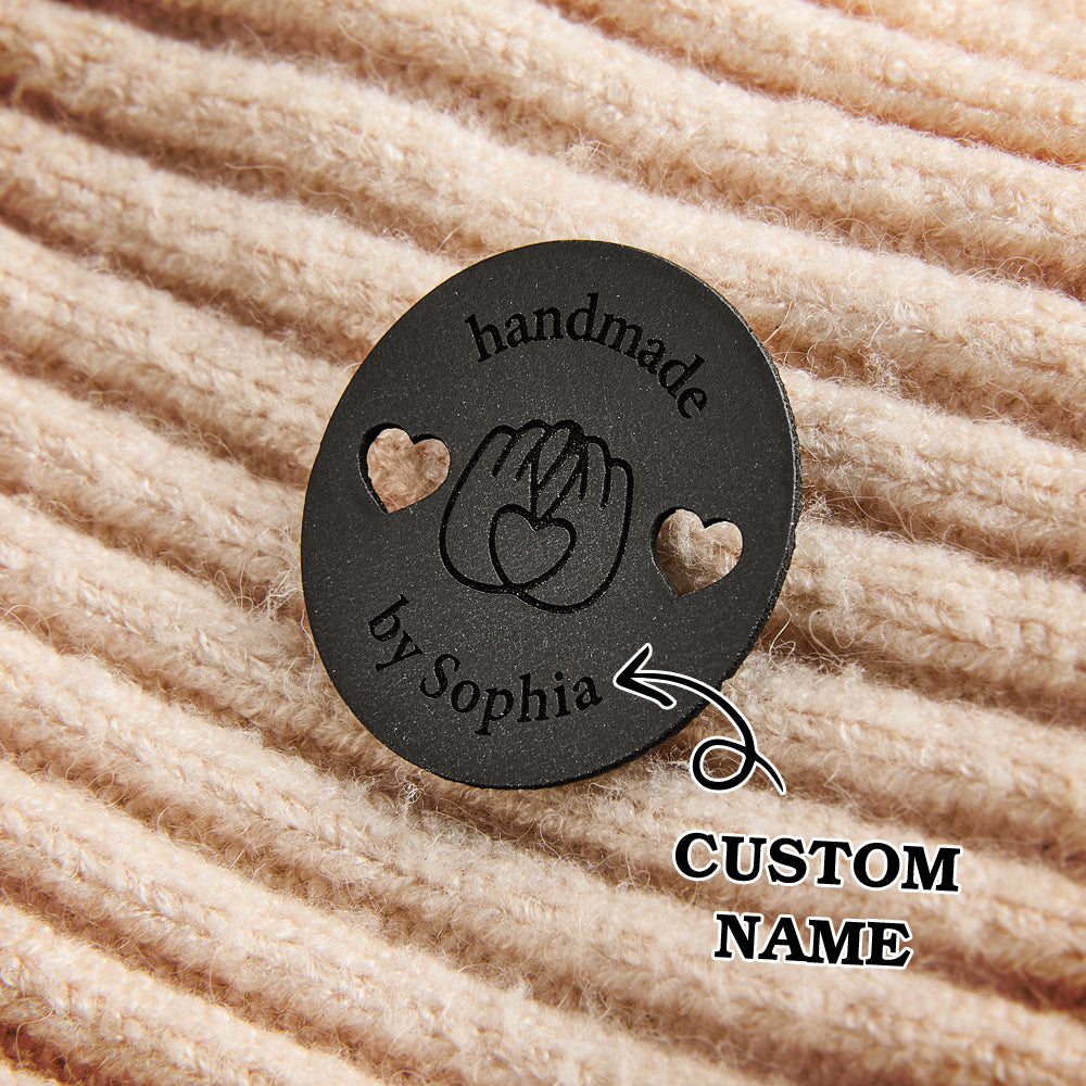 Custom faux leather garment labels for handmade clothing, blankets, and accessories. Engraved name tags for sewing professionals.