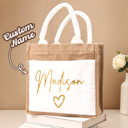 A studio photo of the personalized jute tote bag with text highlighting the customizable name option on the front, showcasing its durable linen fabric and spacious design.