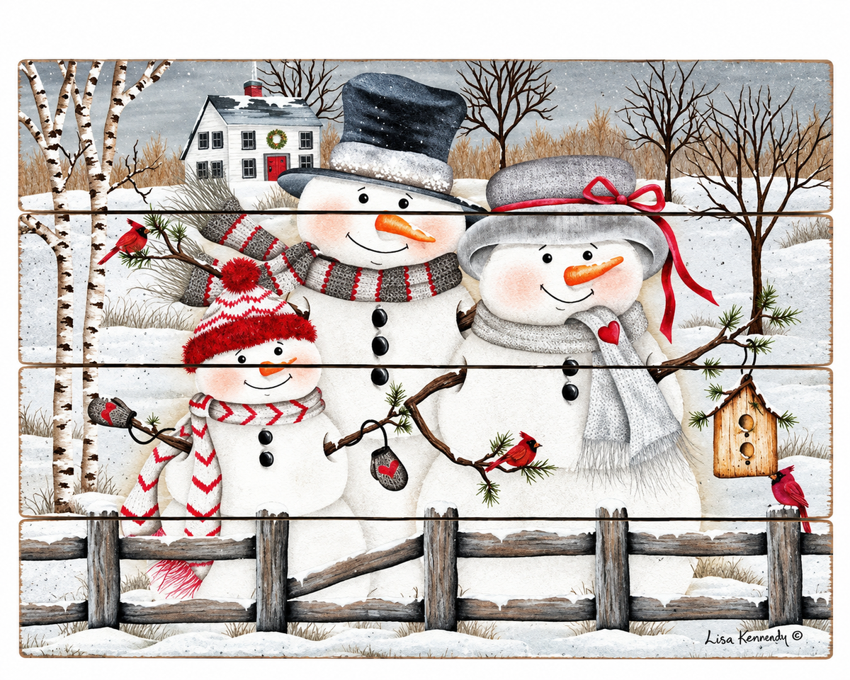 A square decorative sign or print featuring a winter scene with three snowmen in front of a snowy landscape, rustic fence, birch trees, and a house. The sign has horizontal wood-plank panel lines and appears to be sold as wall art or a printed decor item.