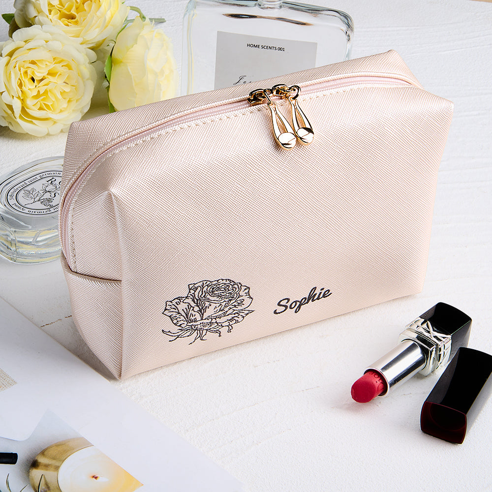 A close-up view of the light pink makeup bag, showcasing the smooth texture and design details.