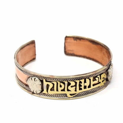 Handmade copper and brass cuff bracelet with intricate Tibetan design, crafted in Nepal.