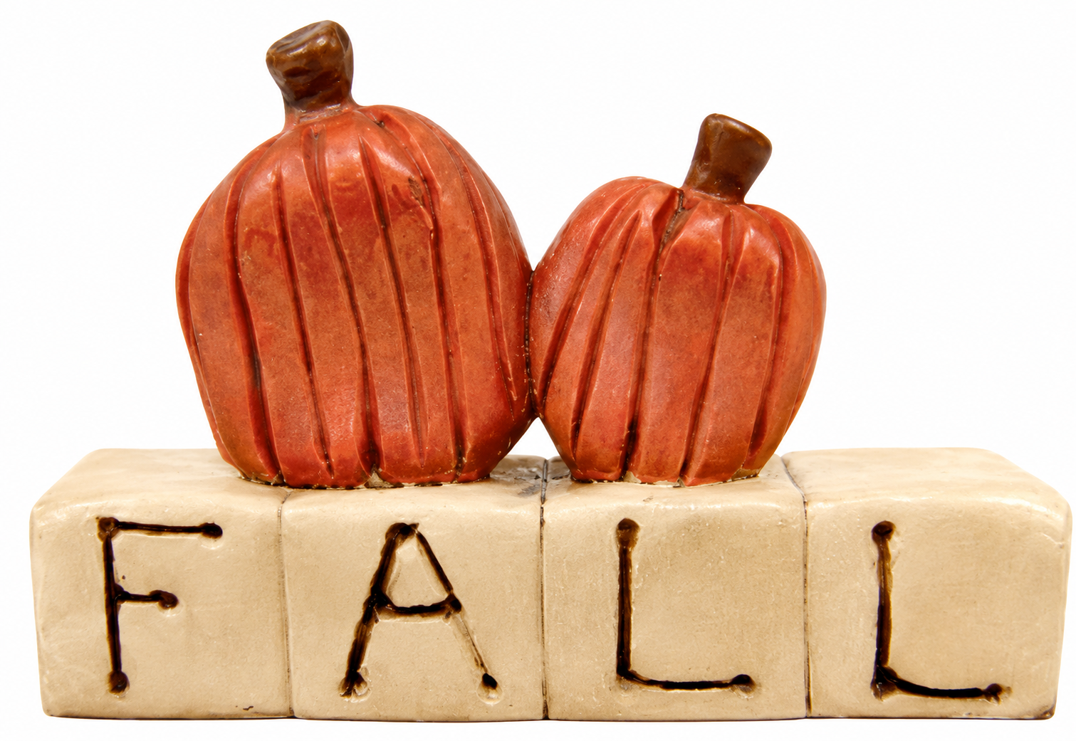 Two small orange-brown decorative pumpkins rest on a beige block spelling FALL, shown against a plain white background.