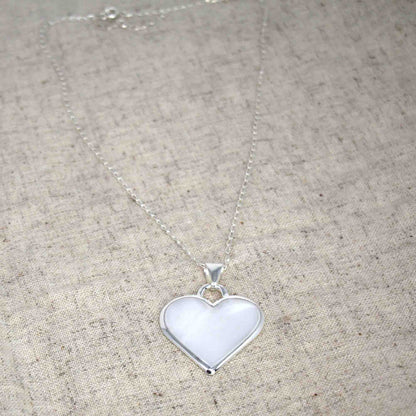 Artisan-made silver pendant in the shape of a heart with adjustable chain