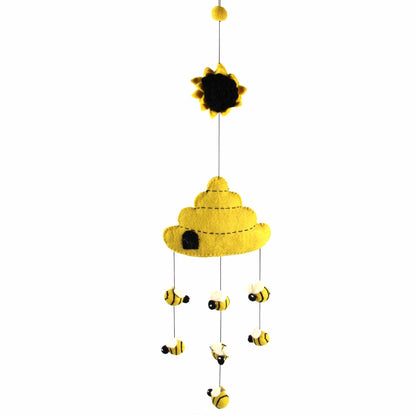 Handmade felt beehive mobile with buzzing bees, crafted from eco-friendly wool in Nepal.