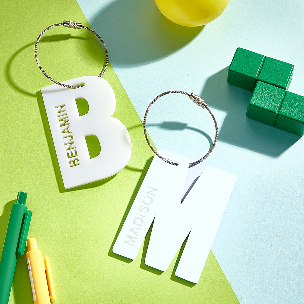 A close-up of the letter B and M in white, showcasing their 3D printed design.