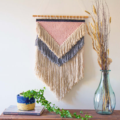 Eco-friendly cotton wall tapestry featuring a blend of soft pink, cream, grey, and charcoal hues.