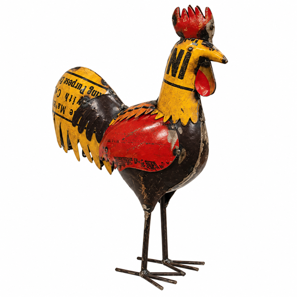 A vintage painted metal rooster figurine with a distressed finish, featuring yellow, red, and black colors with printed text on its feathers, set against a plain white background.