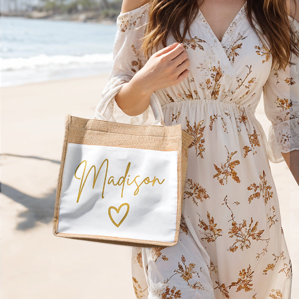 A woman walking along the beach carrying a personalized jute tote bag, highlighting its durable linen fabric, spacious design, and stylish versatility for everyday use.