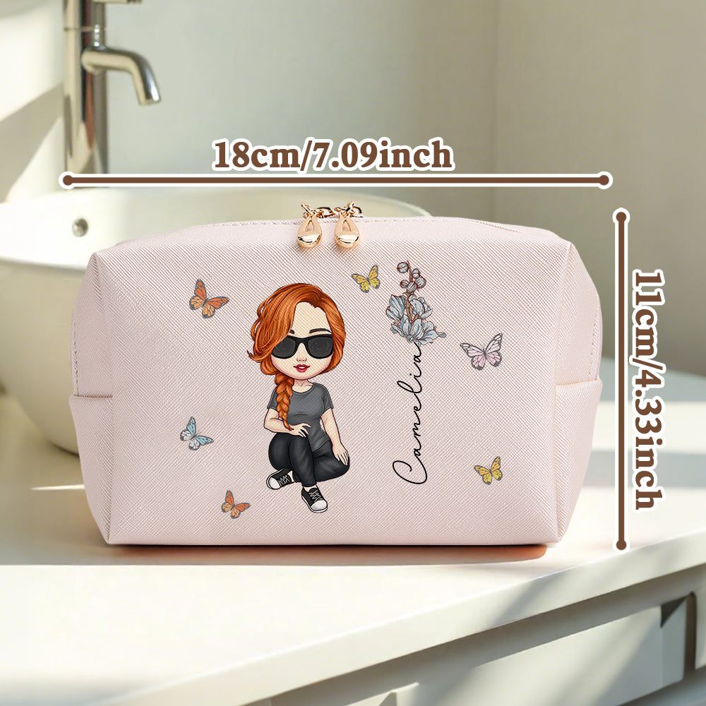 A pink personalized makeup bag sitting on a makeup table, featuring a different custom character and graphic, with an overlay indicating 7.09 inch by 4.33 inch