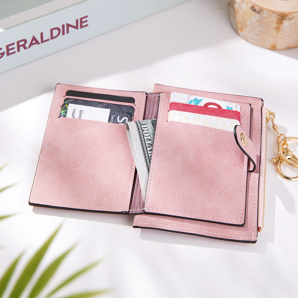 A close-up of the pink vegan leather wallet opened, showing a hidden inside pocket with money inside, ideal for keeping essentials safe and organized.