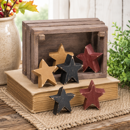 Set of six primitive wooden stars in mustard yellow, burgundy and black with distressed painted finishes.