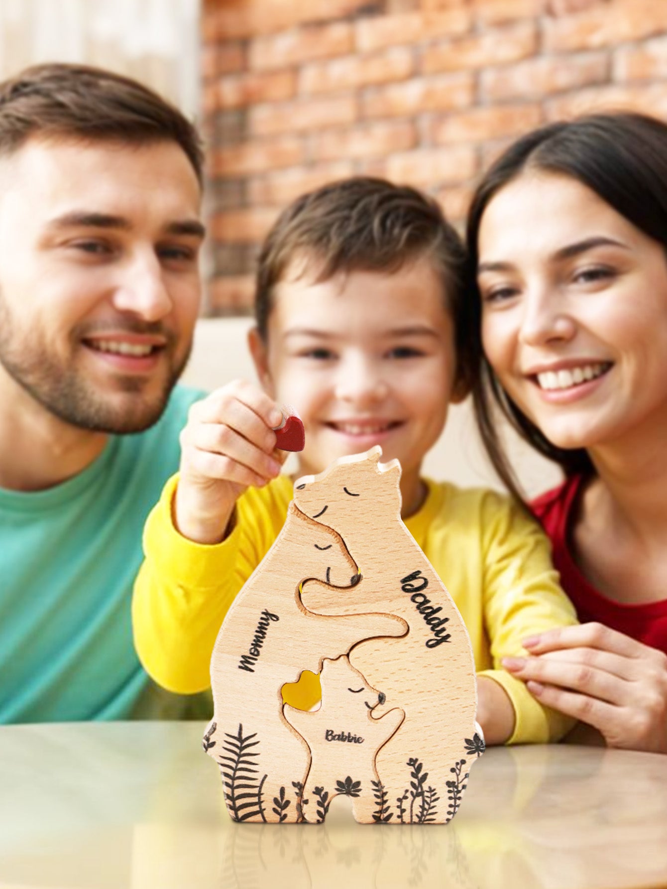 A family admiring a 3-bear wooden puzzle, with the boy holding a heart-shaped piece, personalized with custom names. This charming and thoughtful family keepsake is perfect for anniversaries, family celebrations, and personalized gifts to create lasting memories.