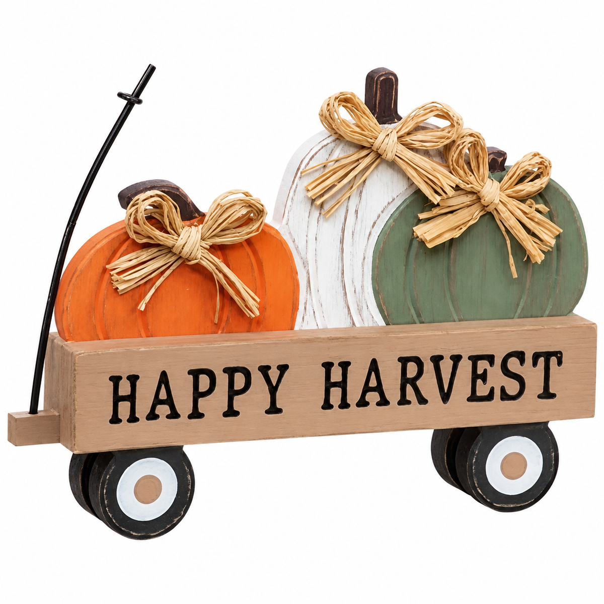 A decorative autumn harvest sign featuring three faux pumpkins in orange, white, and sage green inside a wooden cart with the words 'HAPPY HARVEST' printed on the front. The pumpkins are tied with tan raffia-style bows, and the cart has black wheels on a plain white background.