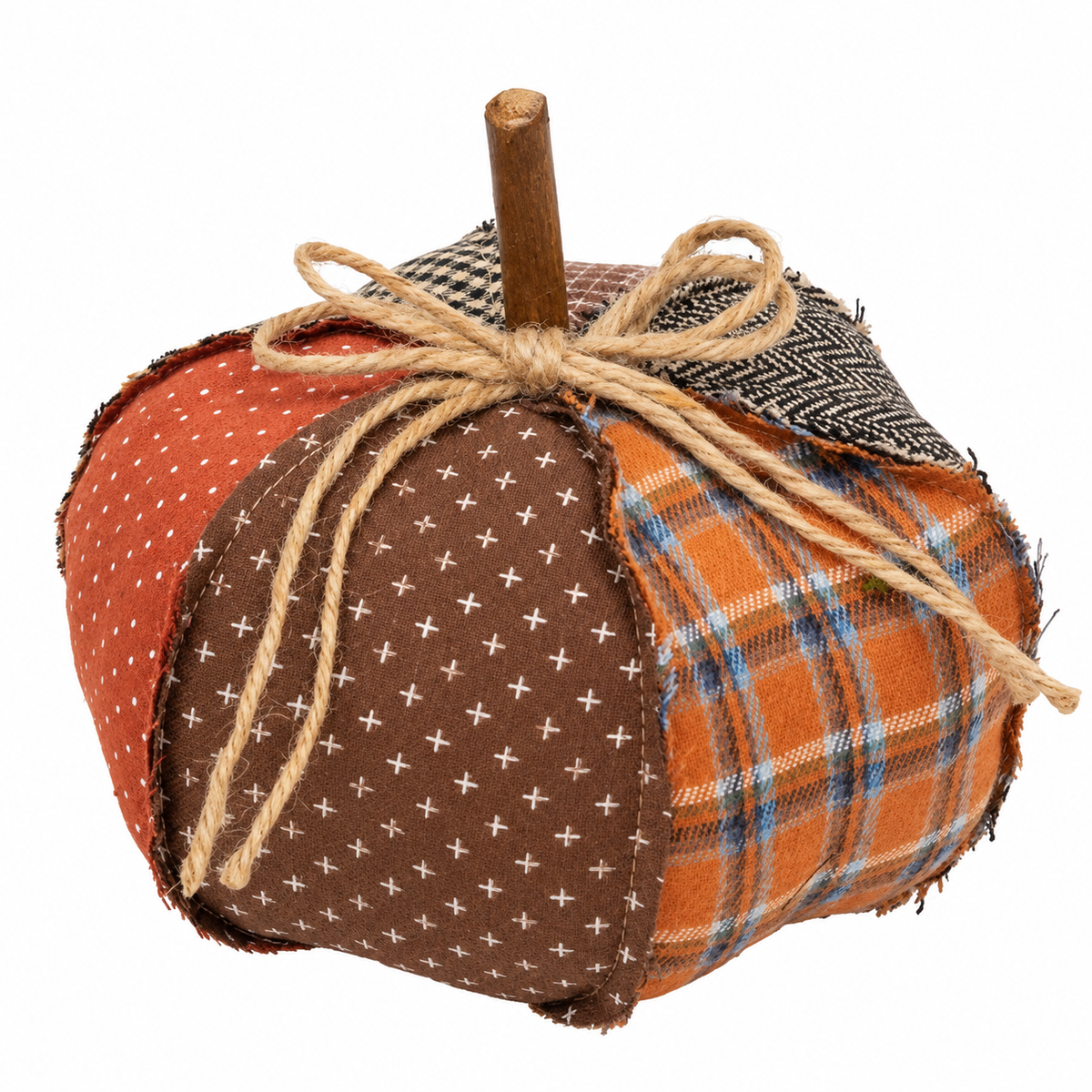 A handmade fabric pumpkin decoration with a wooden stem, featuring three distinct fabric panels: rust orange with white polka dots, medium brown with small white cross patterns, and orange with blue and white plaid. It is tied with a rustic jute twine bow.