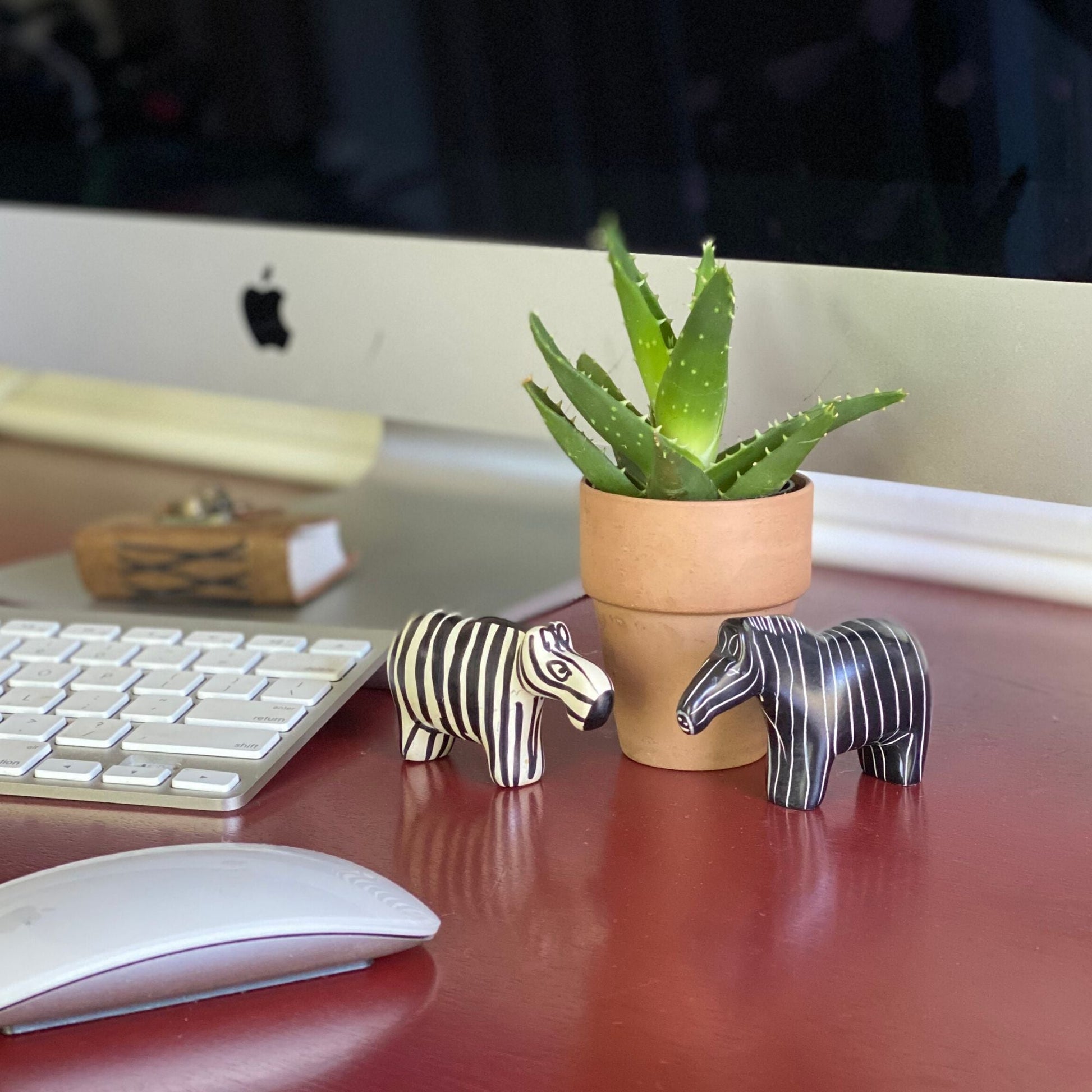 Complementary soapstone zebras perfect for desk or shelf decor