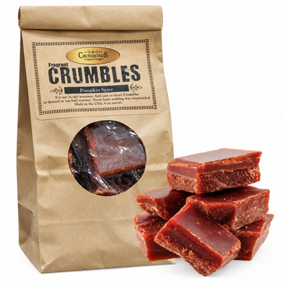 A kraft paper bag of Crumbles Fragrant Crumbles Pumpkin Spice candy with several pieces of the reddish-brown candy displayed in front on a white background.
