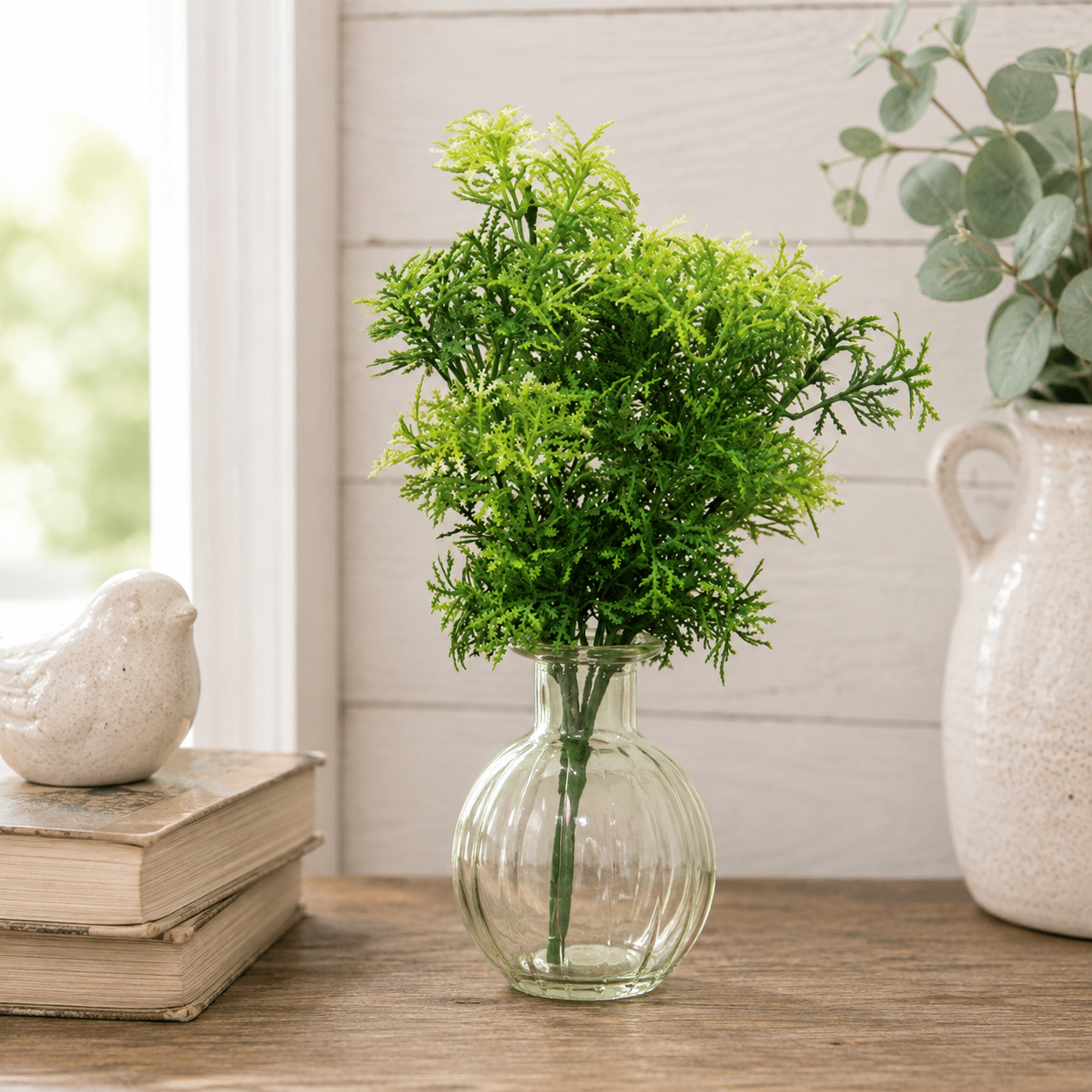 Forest Moss greenery pick with fine leafy branches in layered pale, light, and dark green tones extending from a green stem.