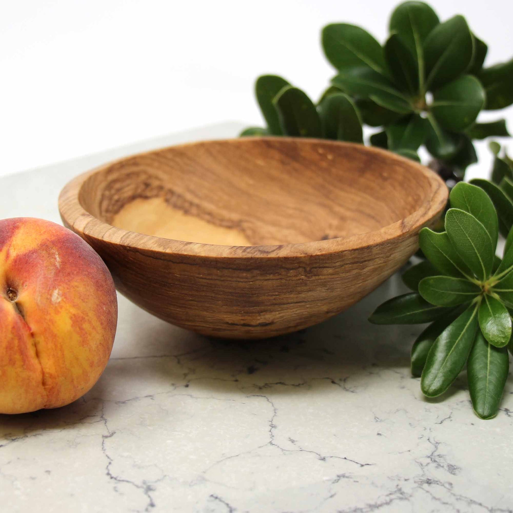 African olive wood bowl with unique variations, shaped using traditional hand tools.