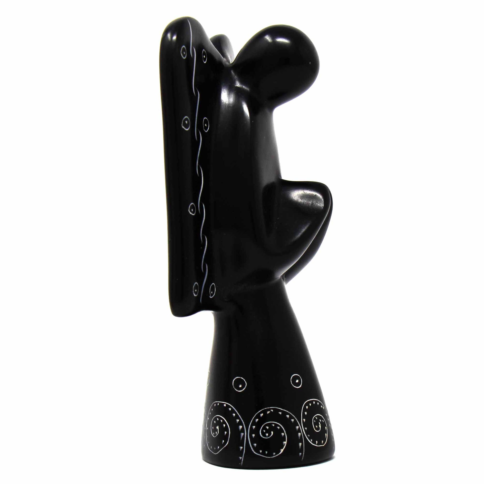 Black soapstone angel figurine showing etched wing patterns